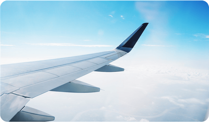 A wing of an airplane in flight