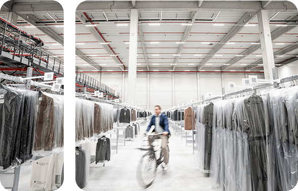 Man riding a bicycle through a modern warehouse 