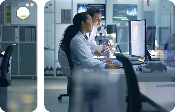 Two medical employees working on the computer.