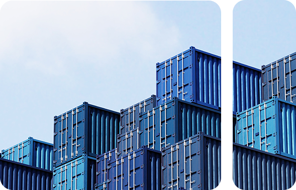 Blue transport containers stand outside under a blue sky