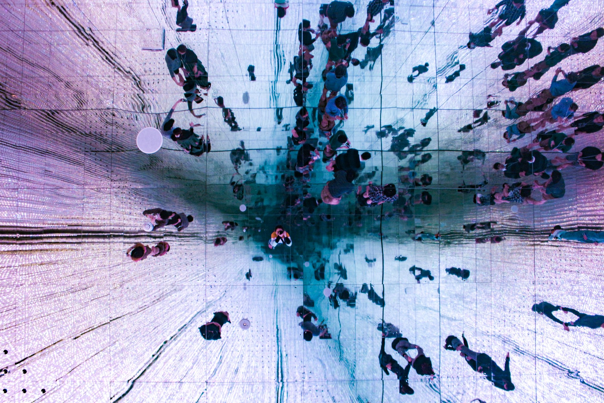 low-angle-view-of-ceiling-mirror-showing-people-s-2025-01-08-20-36-08-utc