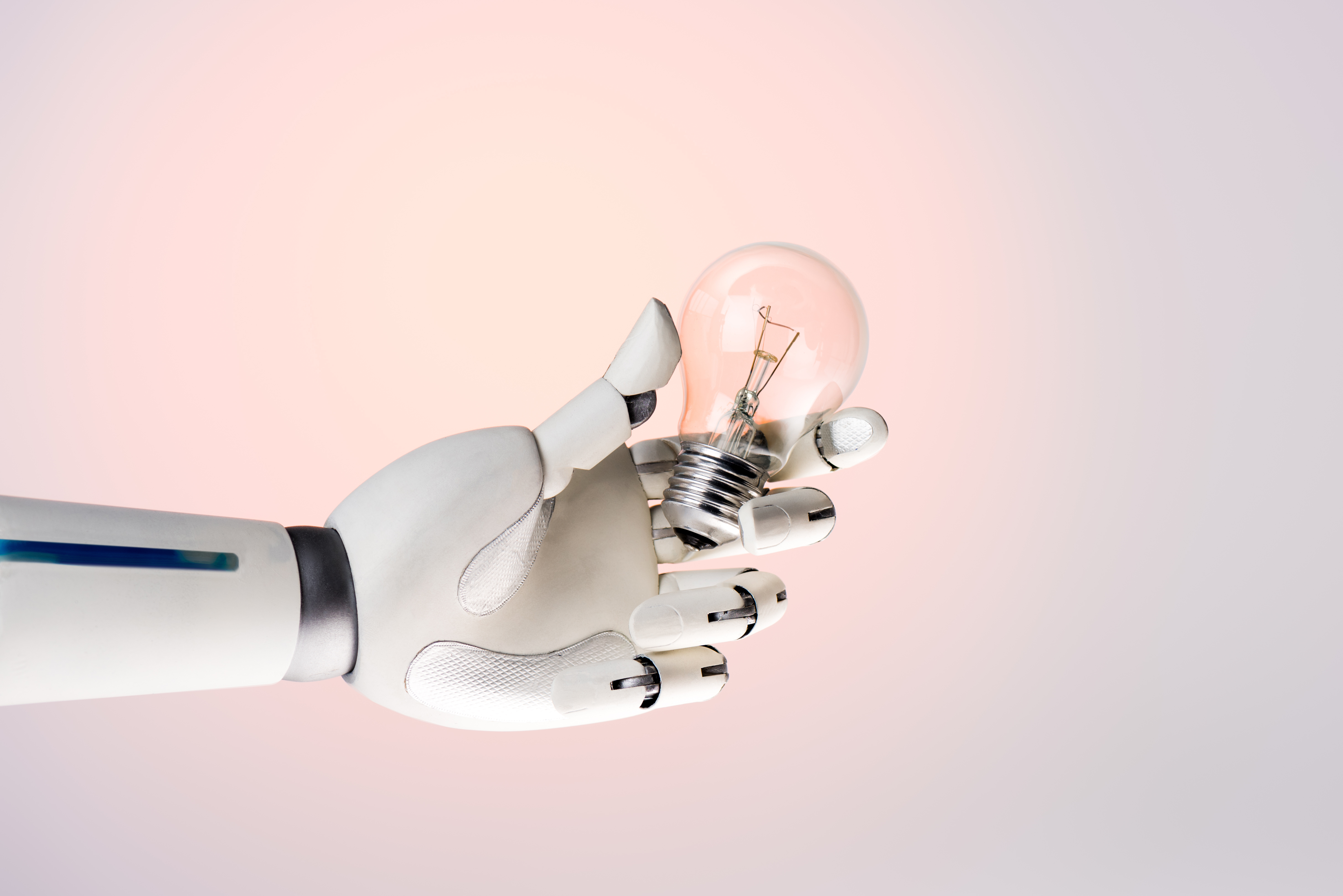 robot-hand-holding-lamp-isolated-on-beige-2024-11-19-01-56-25-utc